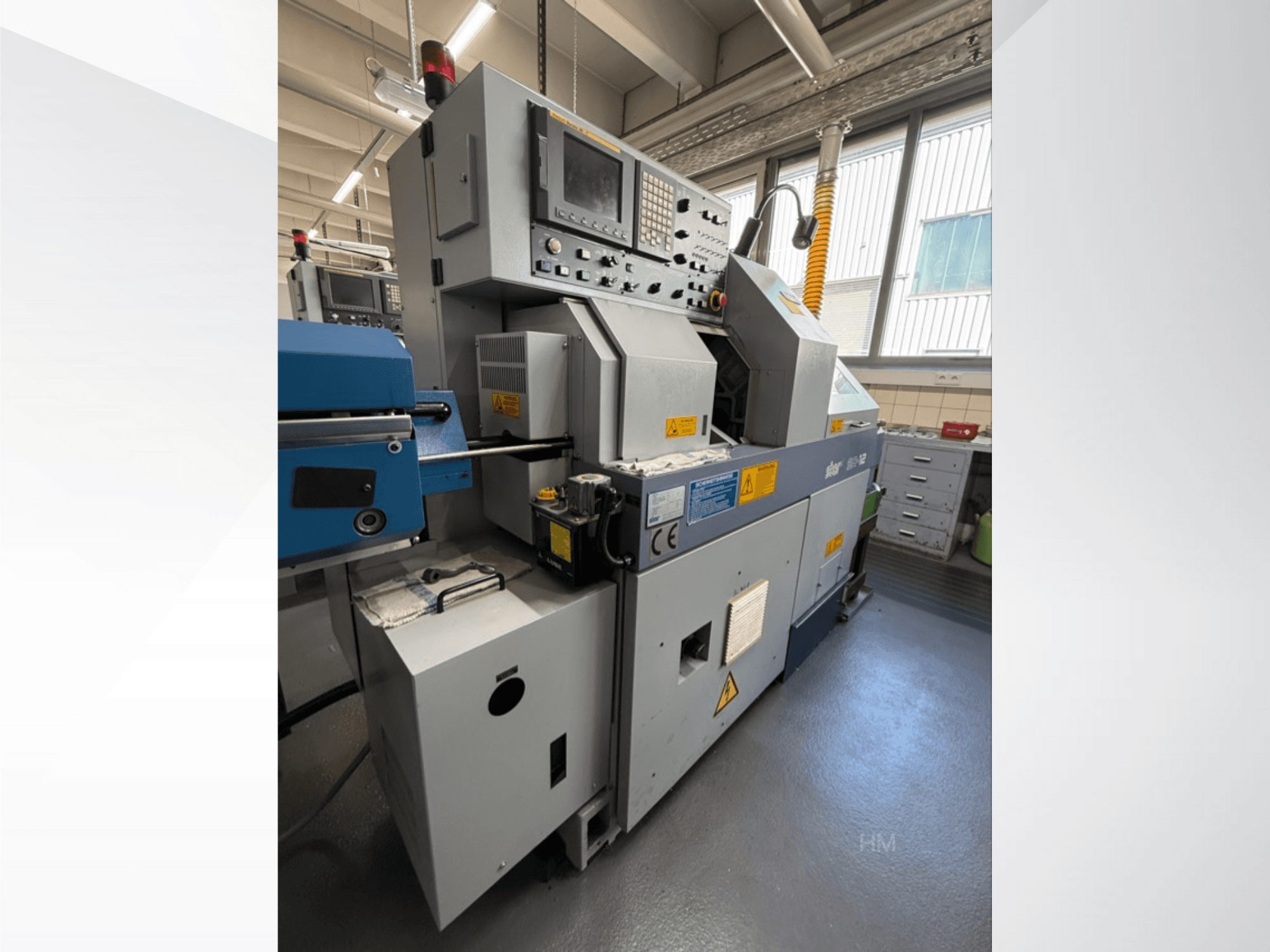 A lithec 3231 gép előlapja, a vezérlőpanel, a motor és a kék adagoló részleg jól megvilágított ipari környezetben.