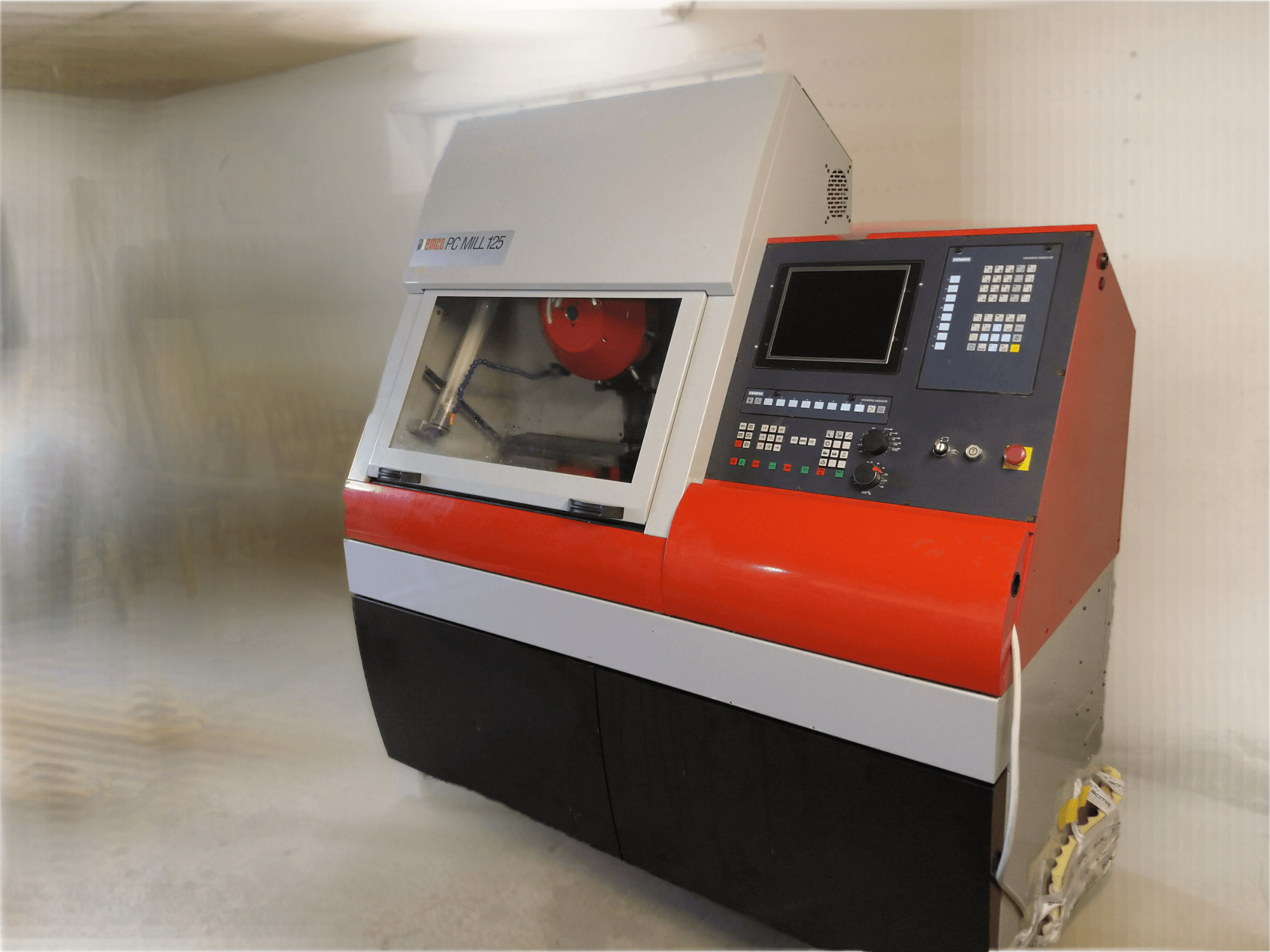 EMCO PC MILL 125 függőleges megmunkálóközpont, elölnézet a kezelőpanellel és a látható megmunkálási területtel.