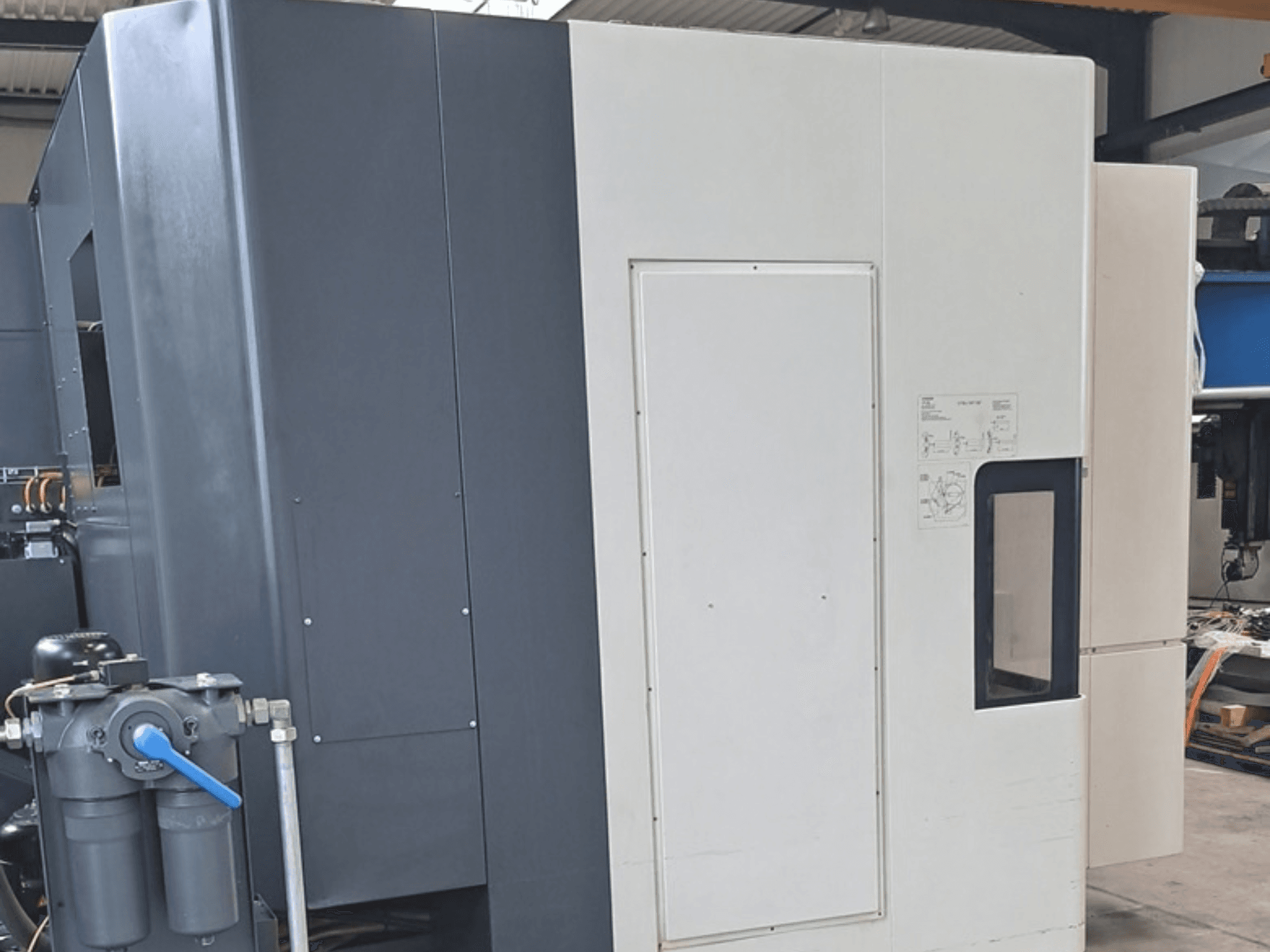 DMG MORI NHX5000 vízszintes megmunkáló központ, oldalnézet a vezérlőpanellel és a mechanikai jellemzőkkel.