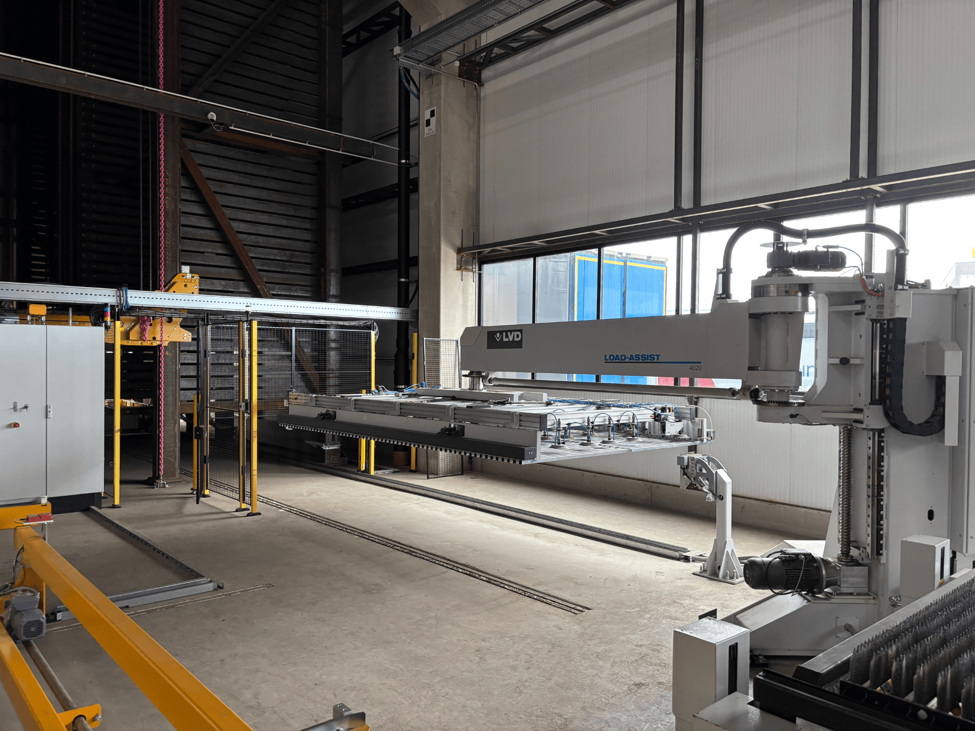 LVD Load-Assist 4020 automatizálási berendezés elölnézetben, a robotkar és a rakodórendszer látható egy nagy munkaterületen.