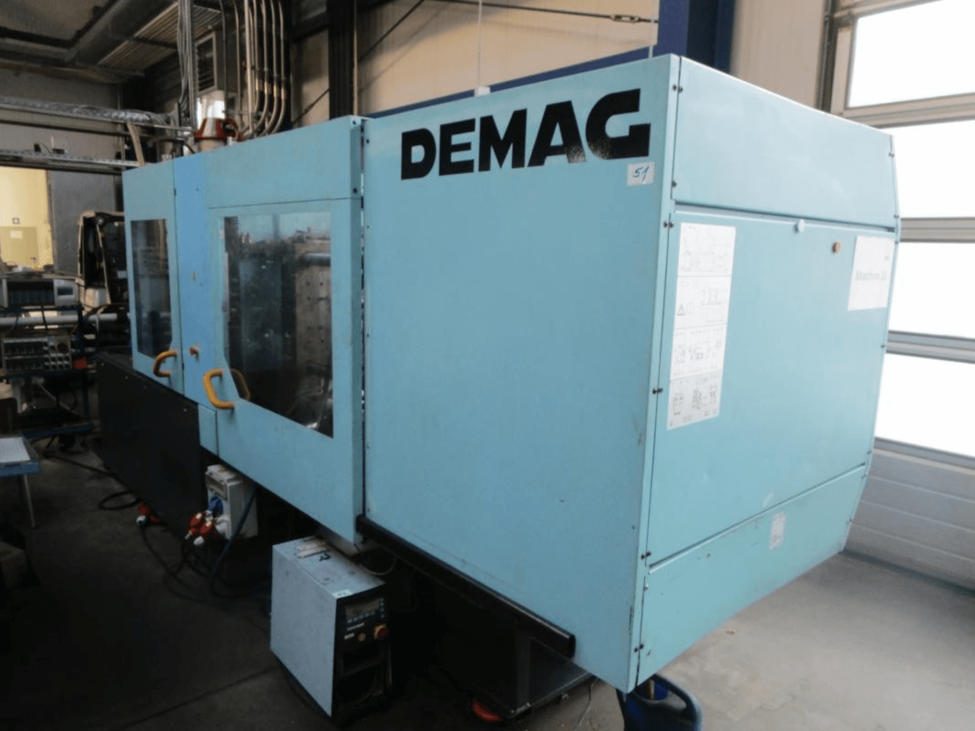 A DEMAG Ergotech 150-610 Viva hidraulikus fröccsöntőgép elölnézete, amelyen jól látható a vezérlőpanel és a fogantyúk.