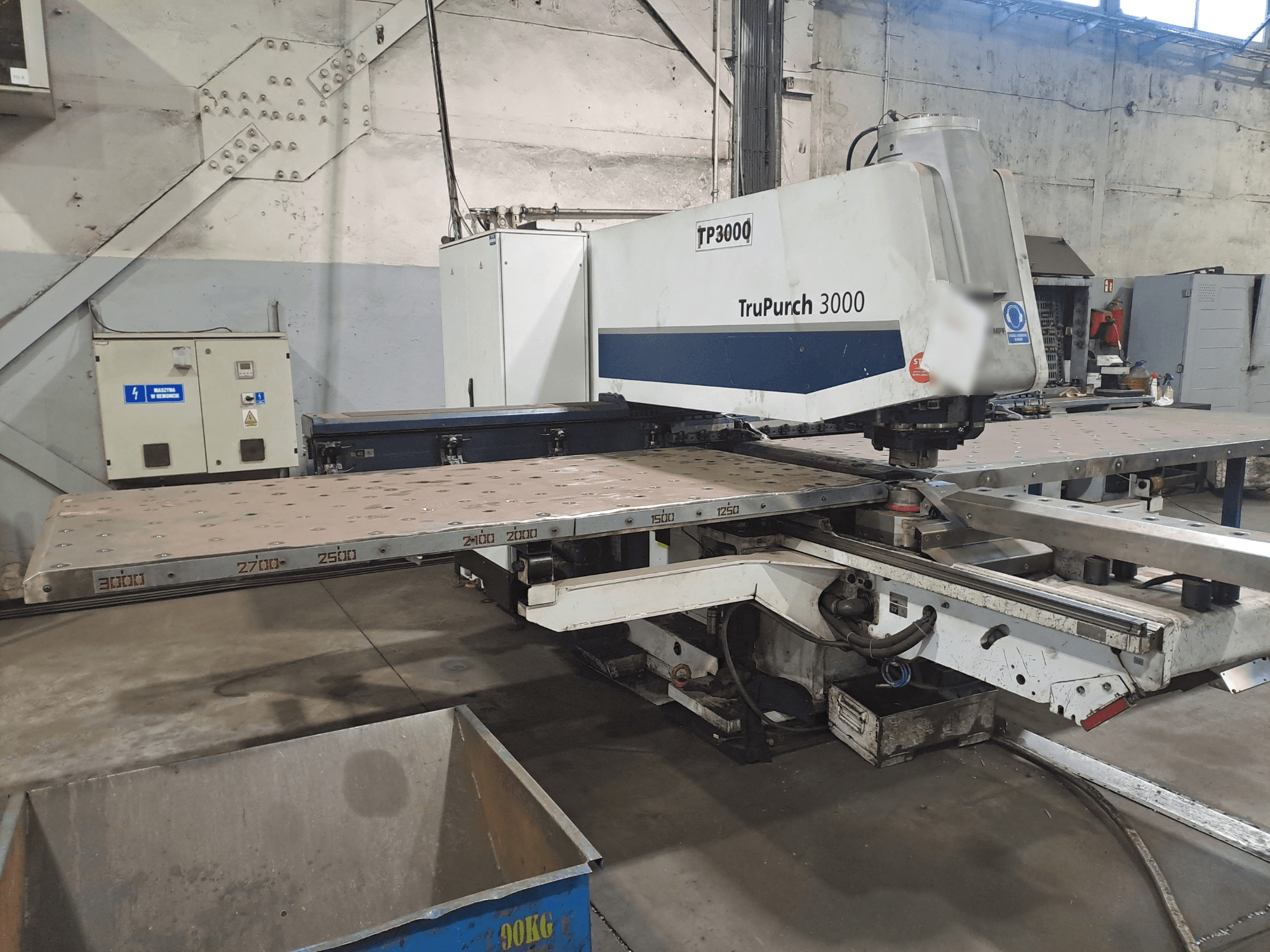 TruPunch 3000 CNC gép szemből, nagyméretű fémlemezzel és mérési jelölésekkel, ipari környezetben.