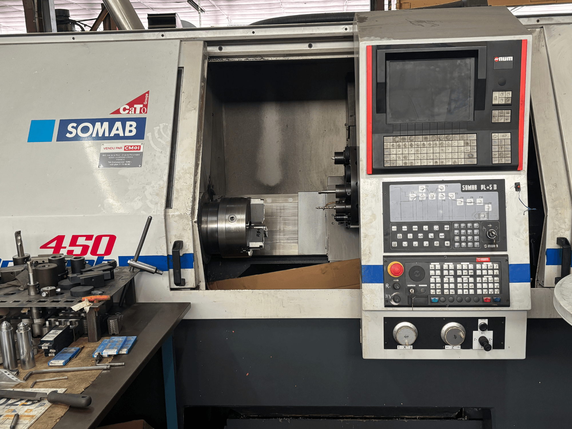 A fehér SOMAB OPTIMA 450 vízszintes eszterga elölnézete, digitális vezérlőpanellel és behelyezett munkadarabbal.