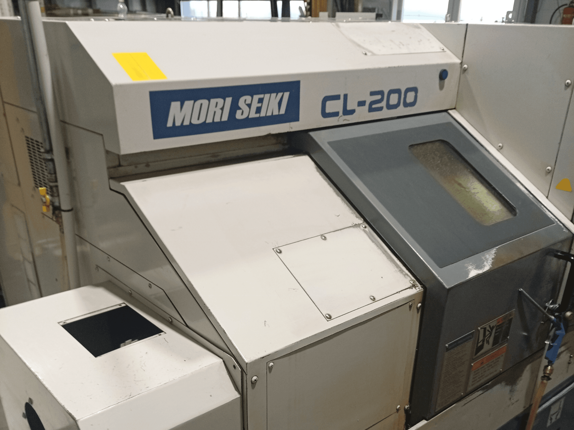 DMG Mori Seiki CL-200B vízszintes esztergagép, elölnézetben a vezérlőpanel és a hűtőfolyadék ablak részletei.