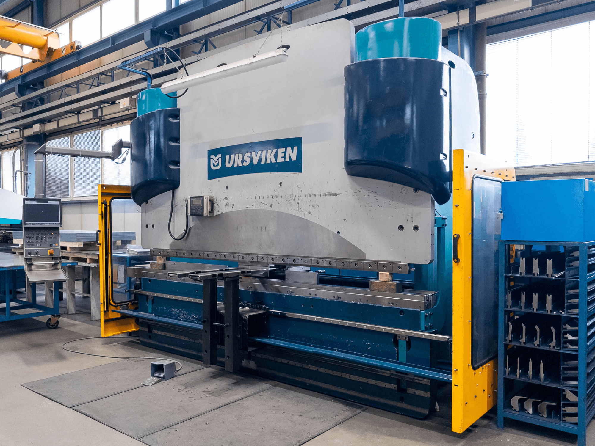 Az Ursviken Optiflex 130 3.1M sajtolóprés gyártási környezetben, az elülső nézet és a vezérlőpanel bemutatása.